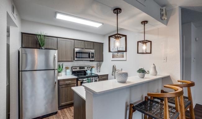 a kitchen with a table and a refrigerator