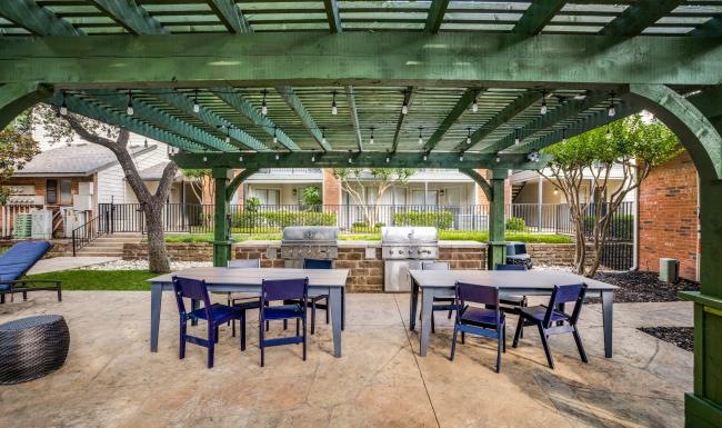 a patio with tables and chairs