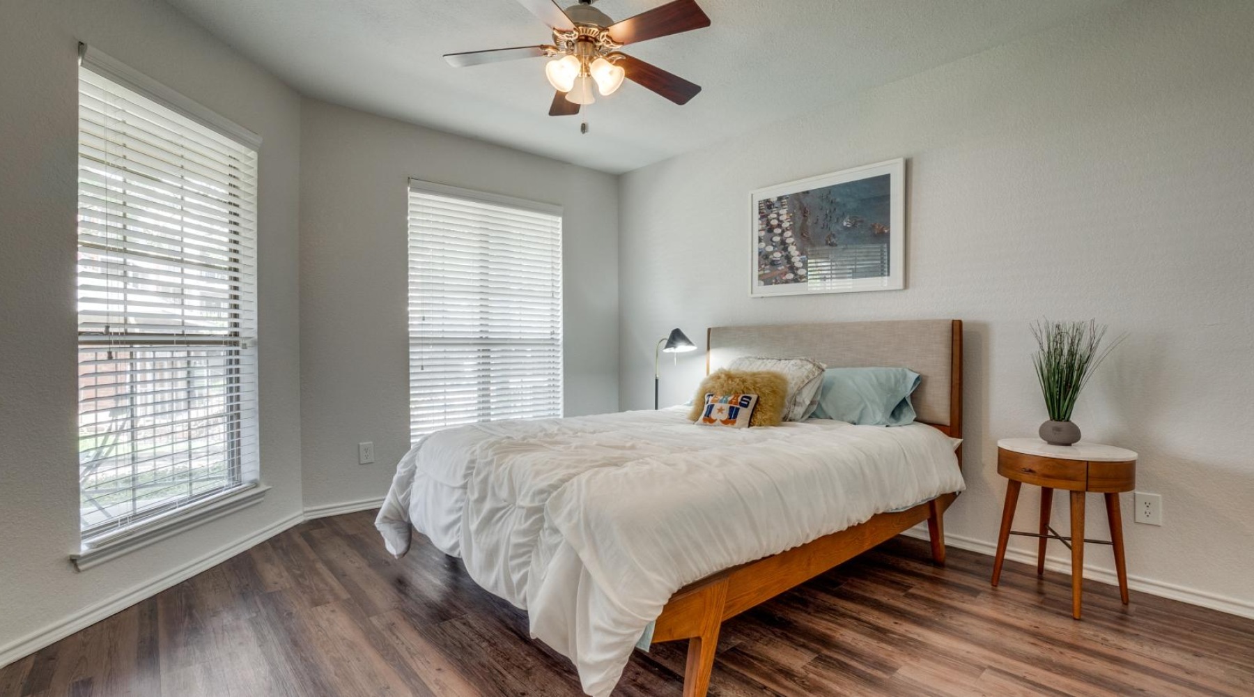 a bedroom with a bed and a fan