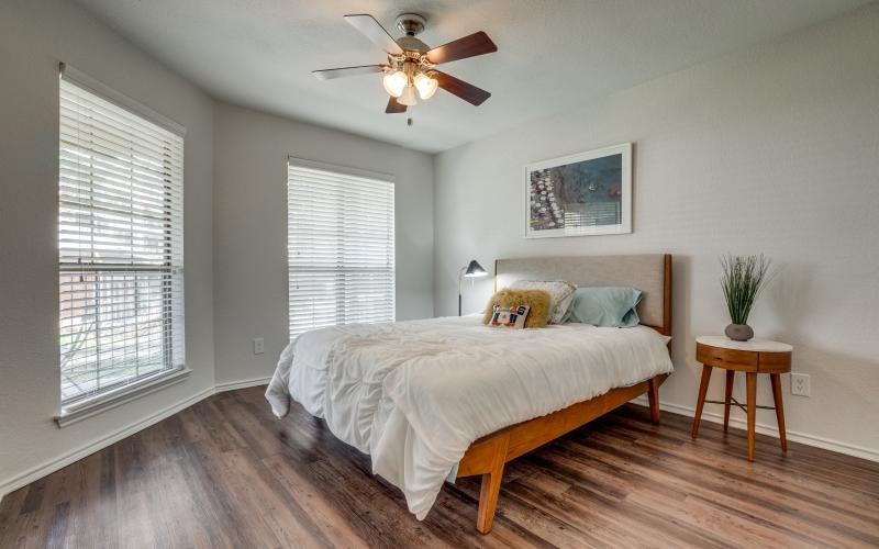 a bedroom with a bed and a fan