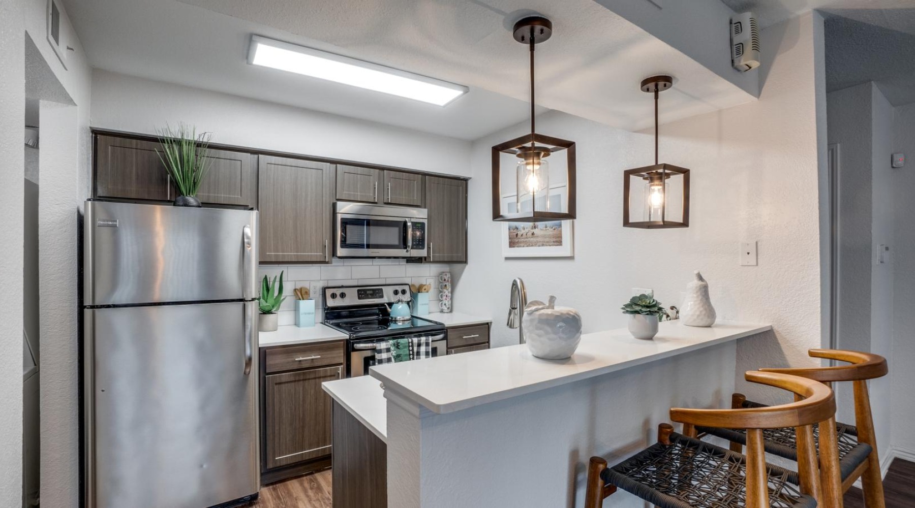 a kitchen with a table and a refrigerator